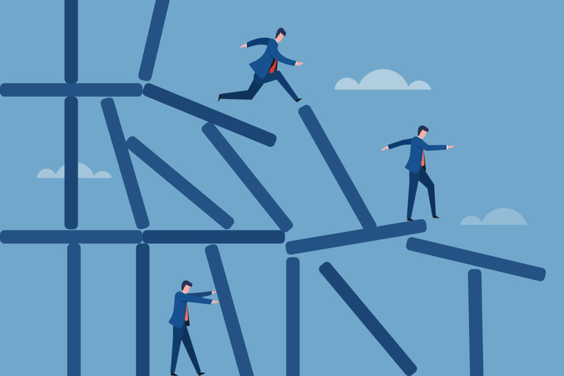 Business executives standing on a collapsing structure.Concept of meeting the challenges in business.