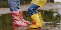 Kids in a puddle. Child having fun outdoors.